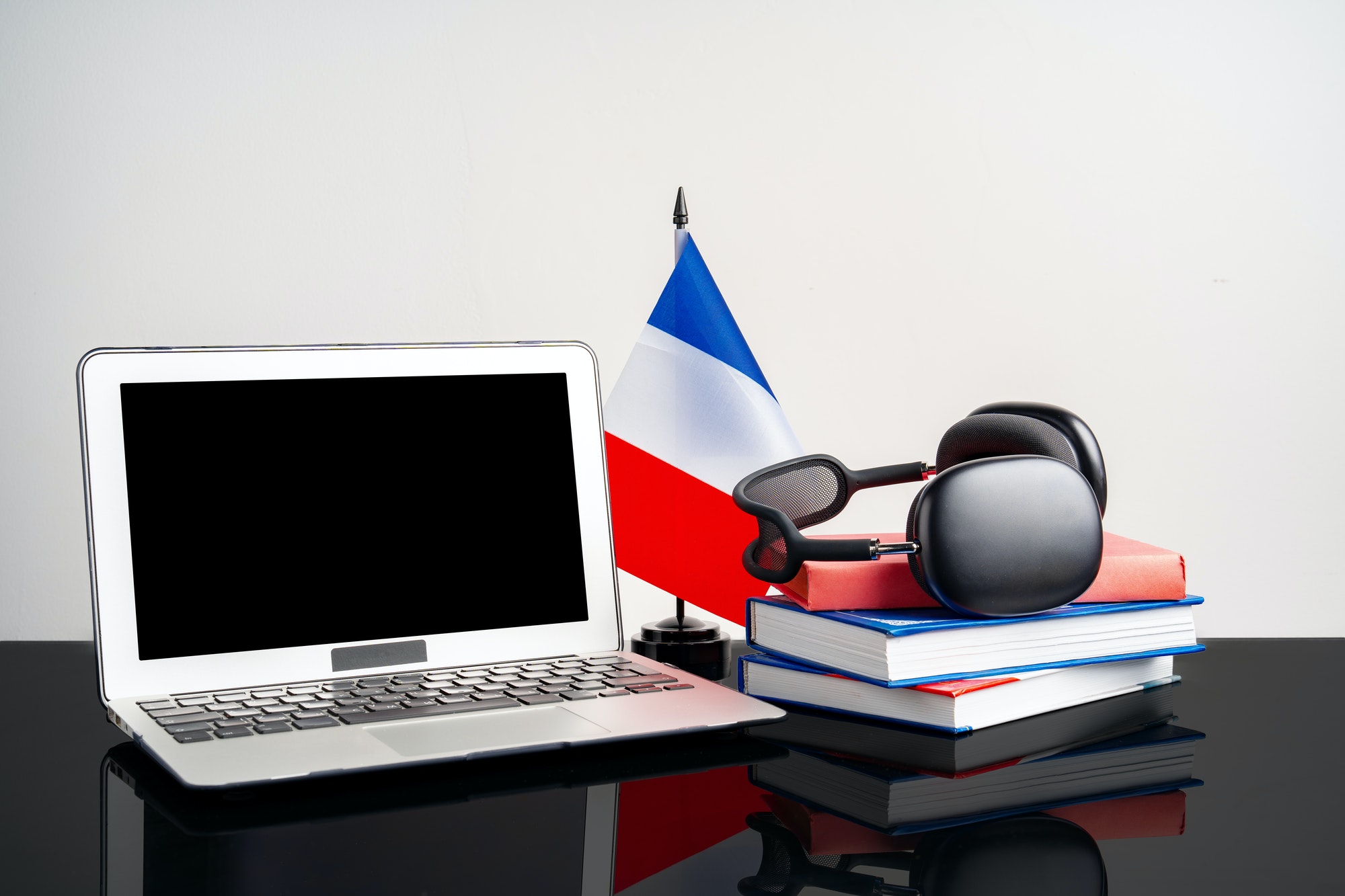 Laptop with flag of France on working table, educational concept