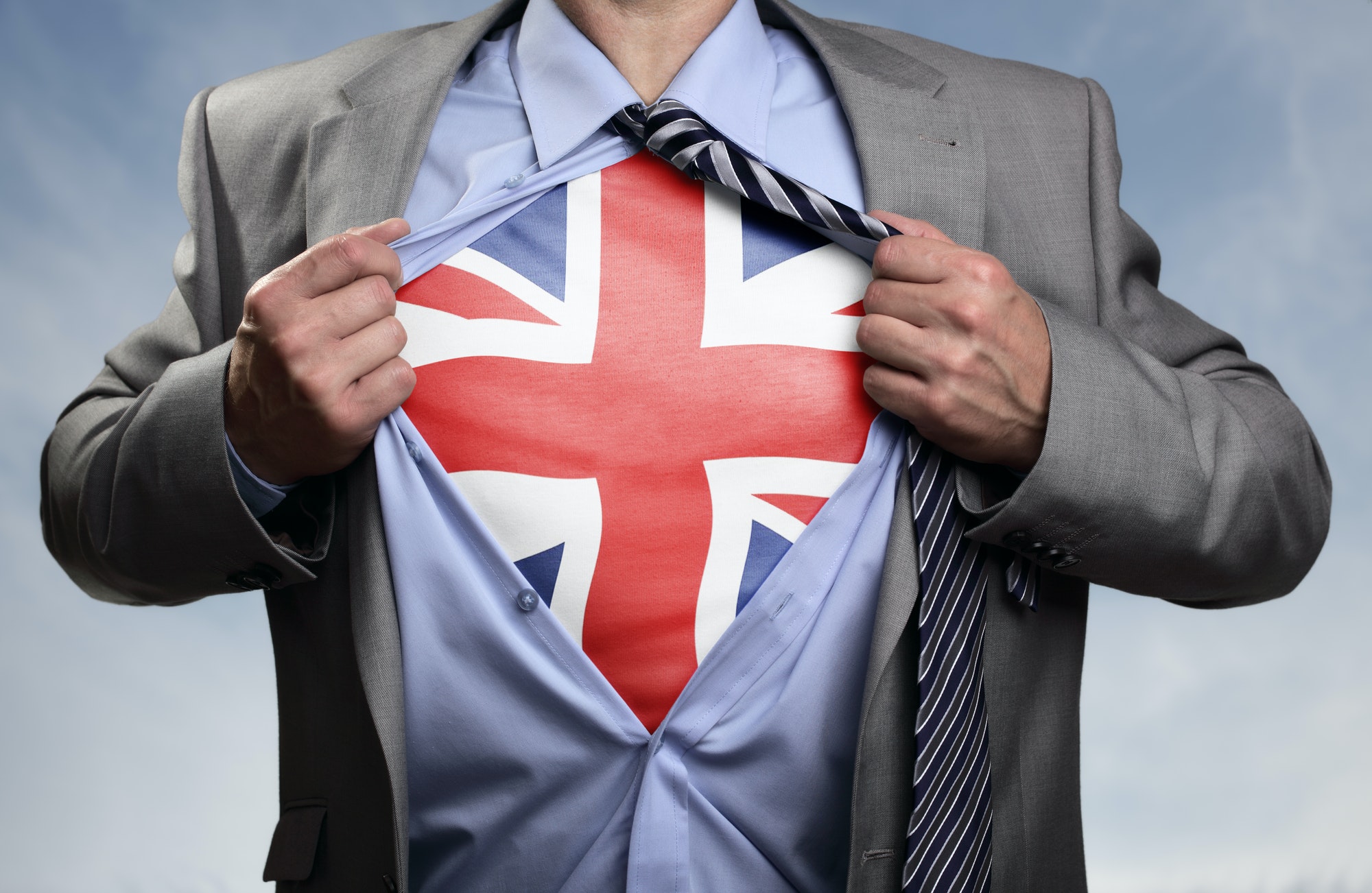 Superhero businessman revealing British flag